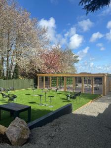 a park with benches and picnic tables in front of a building at Hotel Eighteen92 in Liverpool