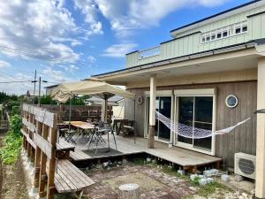 a patio with a hammock on a house at K'sVILLAGE 平砂浦ハウスＳ in Tateyama