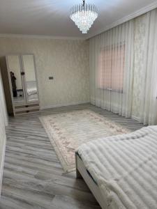 a bedroom with a bed and a chandelier at house for daily rent in Laza +8 photos