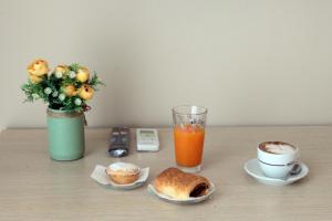 a table with a cup of coffee and a cup of orange juice at Green Wave in Monopoli