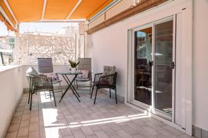 a patio with chairs and a table on a balcony at Il borgo di Ulisse in Gaeta