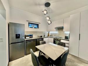 a kitchen with a table and some chairs in it at The Gentle Abode in Sandton