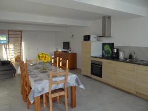 a kitchen and dining room with a table and chairs at Le Galaveyson in Saint-Clair-sur-Galaure +11 photos