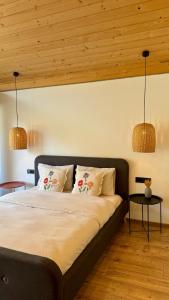 a bedroom with a large bed with two pillows at Boiko house - котеджі з чаном-джакузі та басейном in Slavske
