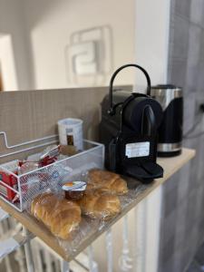 a shelf with a bunch of pastries and a purse at B&B Fiore di Maggio in Mola di Bari