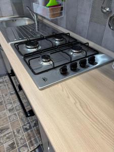 a stove top oven sitting on top of a kitchen counter at B&B Fiore di Maggio in Mola di Bari +5 photos