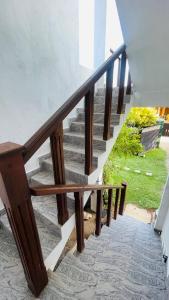 a set of stairs with a wooden rail and a stair case at seaside residence negombo in Negombo +3 photos