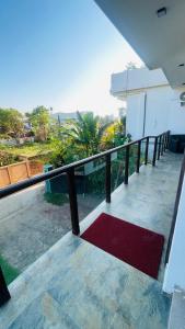 a balcony of a house with a red rug at seaside residence negombo in Negombo