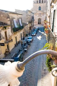 a view of a street with cars parked on the road at BIANCA ROOMS in Noto