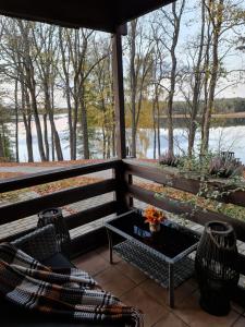 a screened in porch with a view of a lake at Asvejos sodyba in Skirlėnai +1 photo