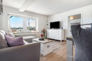a living room with a couch and a tv at Ferienwohnung Wulf in Groß Zicker