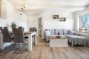 a living room with a couch and a table at Ferienwohnung Wulf in Groß Zicker
