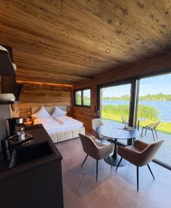 a living room with a bed and a table with chairs at Friesensee Camping und Ferienpark in Wittmund