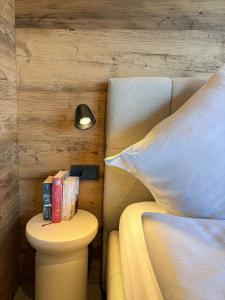 a bedroom with a bed and a table with books at Friesensee Camping und Ferienpark in Wittmund