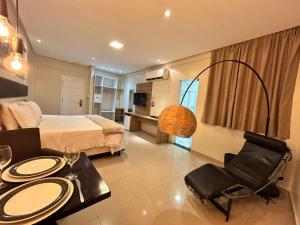 a hotel room with a bed and a table and a chair at Hotel Palace Santarém Brasil in Santarém +38 photos
