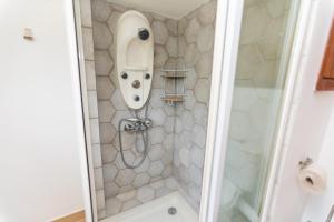 a bathroom with a shower with a sink at Appartement T2 atypique de standing in Pointe-Noire