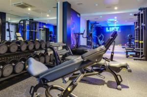 a gym with a bunch of machines in it at P1 The Warren Abersoch in Llanbedrog
