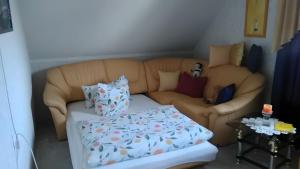 a living room with a couch with pillows at Haus Göhrenz in Markranstädt