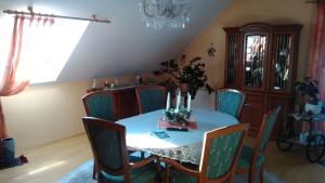 a dining room with a table and chairs and a chandelier at Haus Göhrenz in Markranstädt