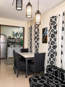 a dining room with a table and chairs at Affordable MODERN Up to 16 Pax Near Aqua Planet & Clark International Airport in Angeles