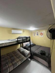 a room with two bunk beds in a room at Affordable MODERN Up to 16 Pax Near Aqua Planet & Clark International Airport in Angeles