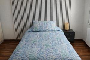 a bed with a blue comforter in a bedroom at B&B Casa Fortunata in Milan +55 photos