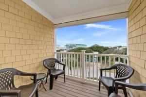 a balcony with chairs and a view of the ocean at Dreamer by Oak Island Accommodations in Oak Island