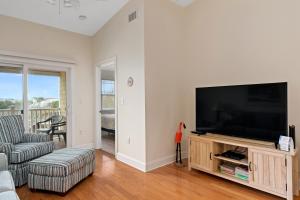 a living room with a flat screen tv and a couch at Dreamer by Oak Island Accommodations in Oak Island