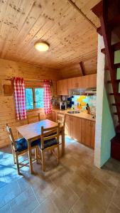 a large kitchen with a wooden table and chairs at Chata Sekule in Sekule