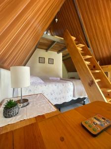 a attic bedroom with a bed and a staircase at #1 Jardín de las cabanas in San Pedro Carchá