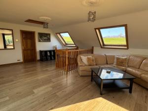 a living room with a couch and a table at Wallace Lodge in Crieff