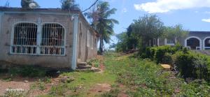 an old building with a gate in a yard at James breazy hill in Sandy Bay