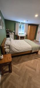 a bedroom with a large bed and a table at furnace halls in Taffs Well