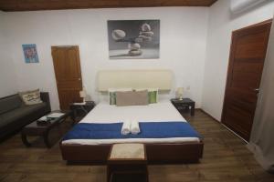a bedroom with a large bed and a couch at Castaway Lodge in Pointe Au Sel 