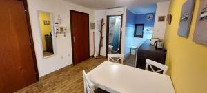 a room with a white table and a kitchen at Terra Apartments in Piran +62 photos