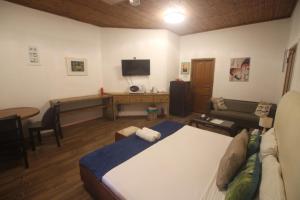 a living room with a bed and a couch at Castaway Lodge in Pointe Au Sel 