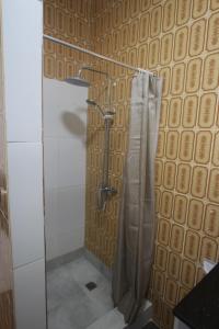 a shower with a shower curtain in a bathroom at Castaway Lodge in Pointe Au Sel  +40 photos
