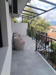 a balcony with chairs and a railing on a building at UB Prenociste in Vranjska Banja