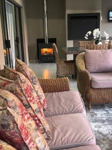 a living room with a couch and a fireplace at 127 Clarens Golf Villa in Clarens