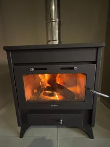 a stove with a fire inside of it at 127 Clarens Golf Villa in Clarens