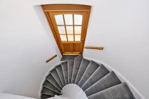 a spiral staircase in a house with a window at Ben Shea Smart Home in Dufftown