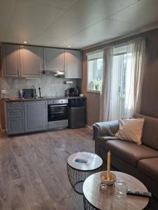 a living room with a couch and a table at Leilighet i Lyngdal in Lyngdal