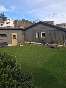 a home with a yard with a house at Leilighet i Lyngdal in Lyngdal