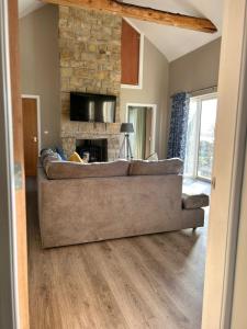 a living room with a couch and a fireplace at Lakeside cottage retreat in Belcoo +9 photos