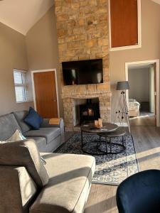 a living room with a couch and a fireplace at Lakeside cottage retreat in Belcoo
