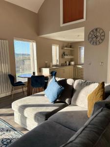 a living room with a couch and a kitchen at Lakeside cottage retreat in Belcoo