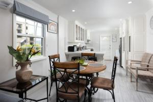 a kitchen and living room with a table and chairs at The White Villa in Saint James +4 photos