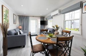 a living room with a table and a couch at The White Villa in Saint James