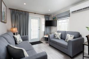 a living room with a blue couch and a chair at The White Villa in Saint James