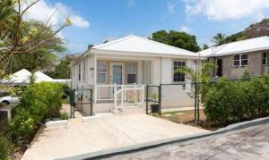 a white house with a gate and a driveway at The White Villa in Saint James
